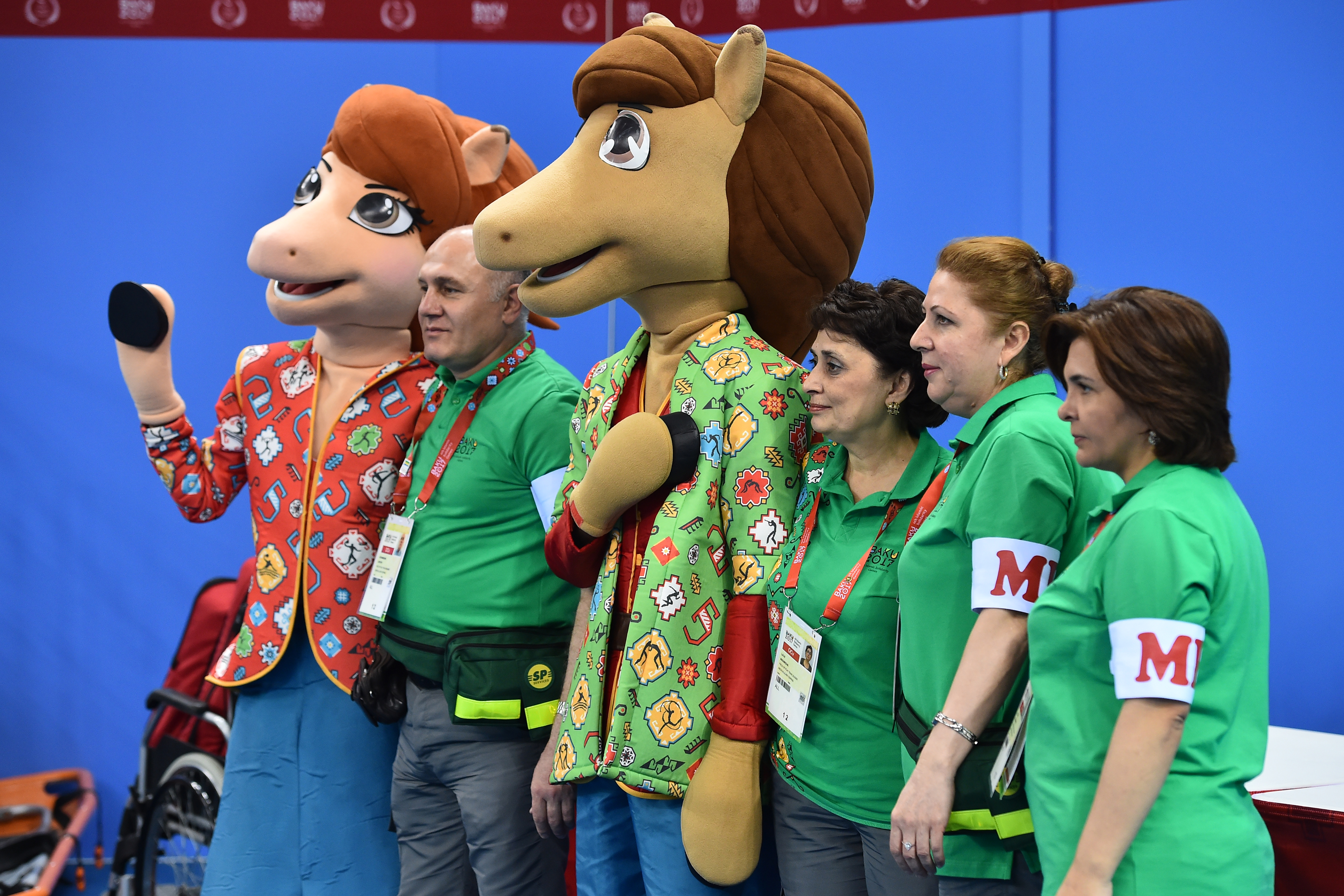 Baku 2017 4th Islamic Solidarity Games' mascots pose with volunteers at the Sarhadchi Sports Olympic Center, in Baku, on May 14, 2017.